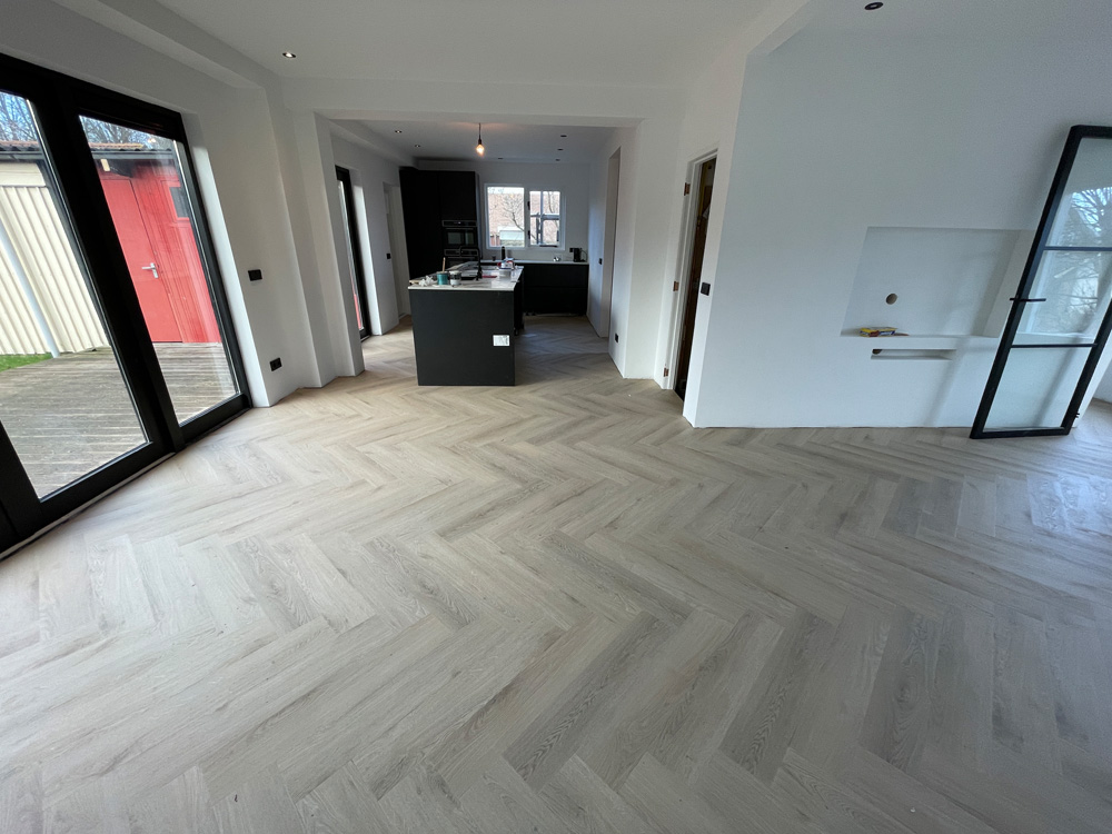 Net gelegde lichte PVC visgraatvloer in een nieuwbouwwoning